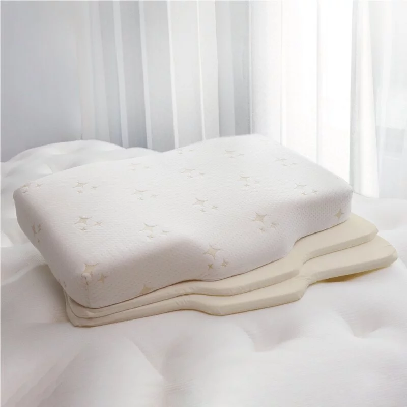 a white bed with a white cover