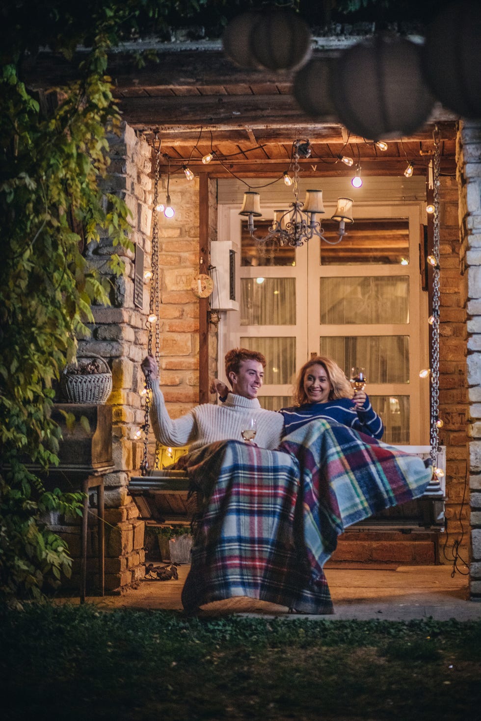 fall porch decor, lovely couple enjoying wine on a porch swing