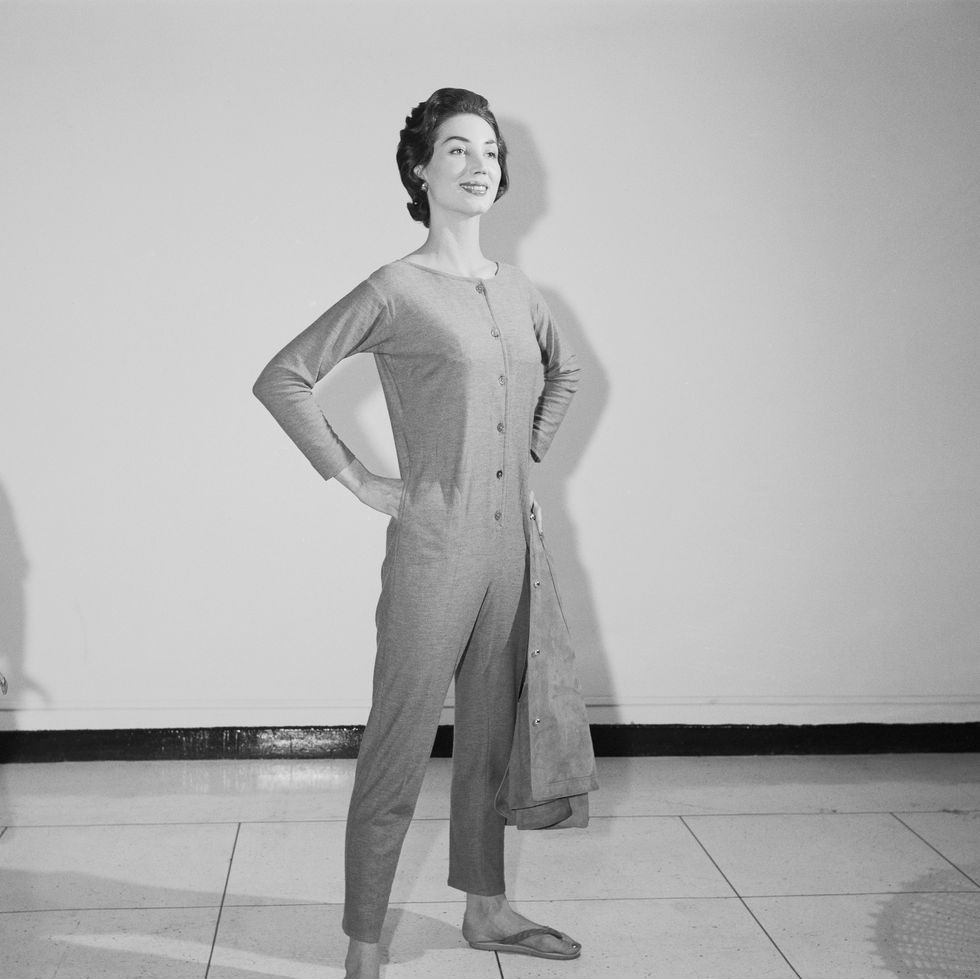 original caption lovely in longjohns new york bonnie cashin revives the old fashioned union suit for leisure wear at home this fall a faithful copy of grandpa's longjohn's, done in currycolored jersey, the novel costume buttons down the front and can be worn with a narrow belt and a variety of casual blouses and jackets the designer also shows a version in fuzzy black mohair, complete with hood and drop seat