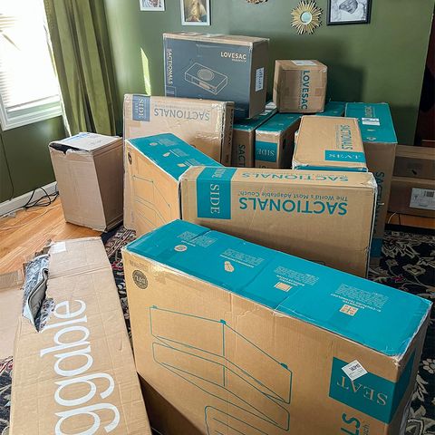 the pile of boxes that the lovesac sactional arrived in inside of cat bowen's home