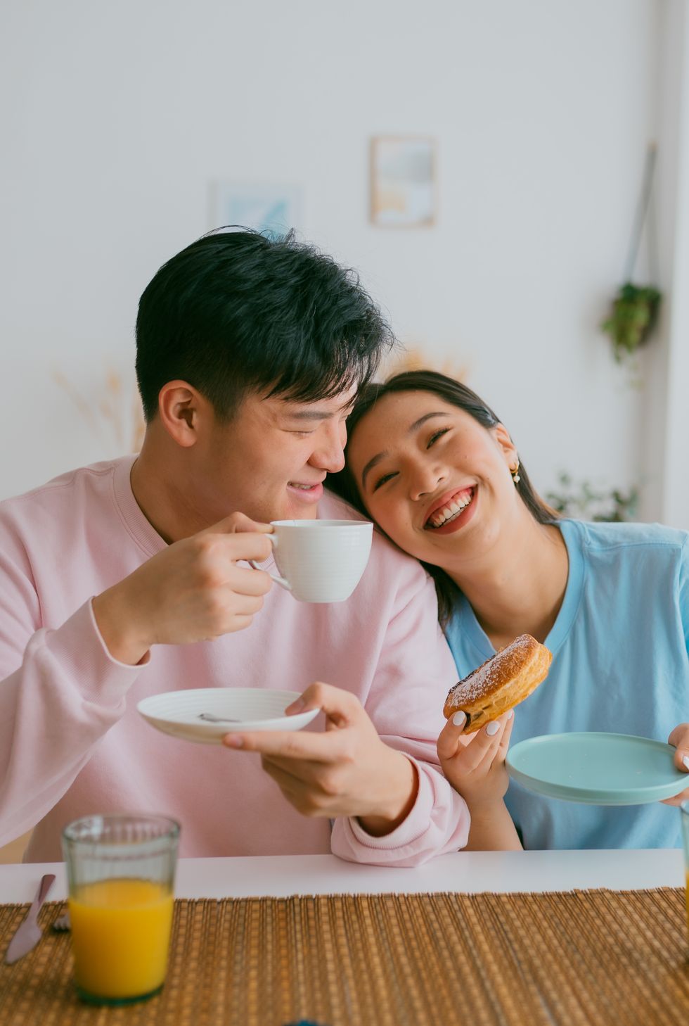 loving asian couple having breakfast together at home