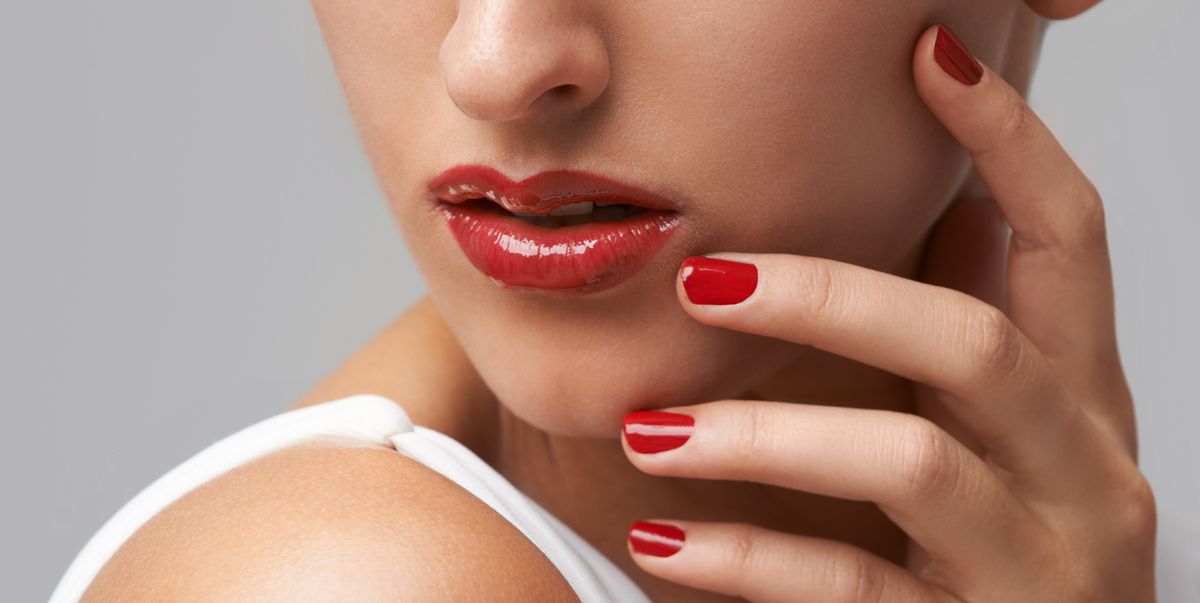 woman red lipstick red nail polish