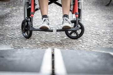 low angle of an image of a person's feet prepared to board a wheelchair ramp