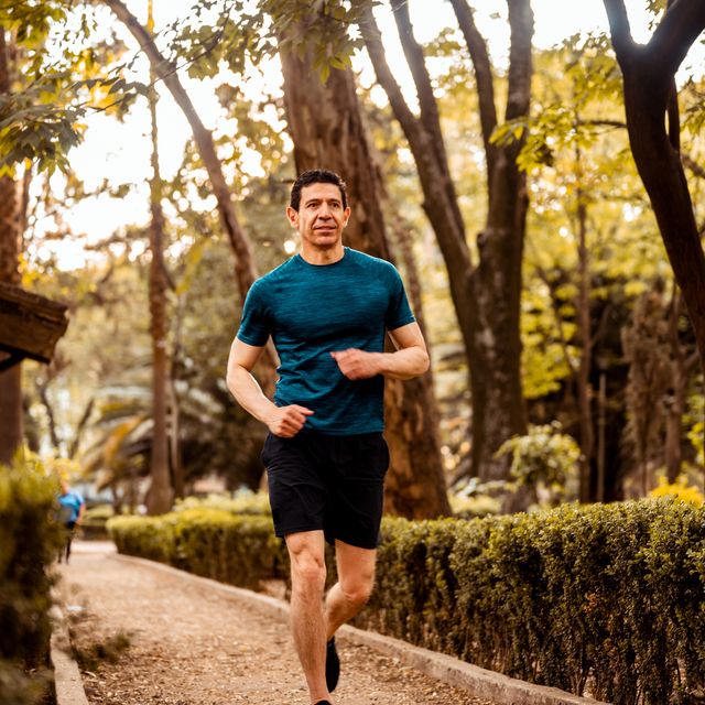 low angle photo of senior athlete running