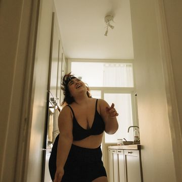 low angle view of happy woman dancing in kitchen at home