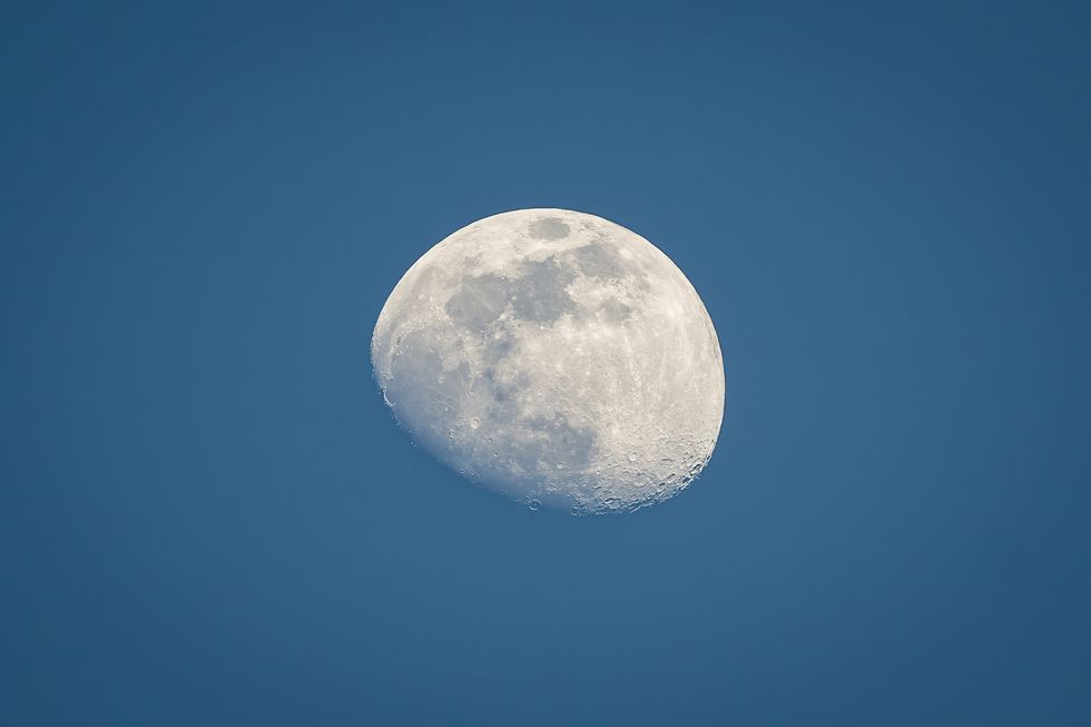 low angle view of moon against clear blue sky,switzerland