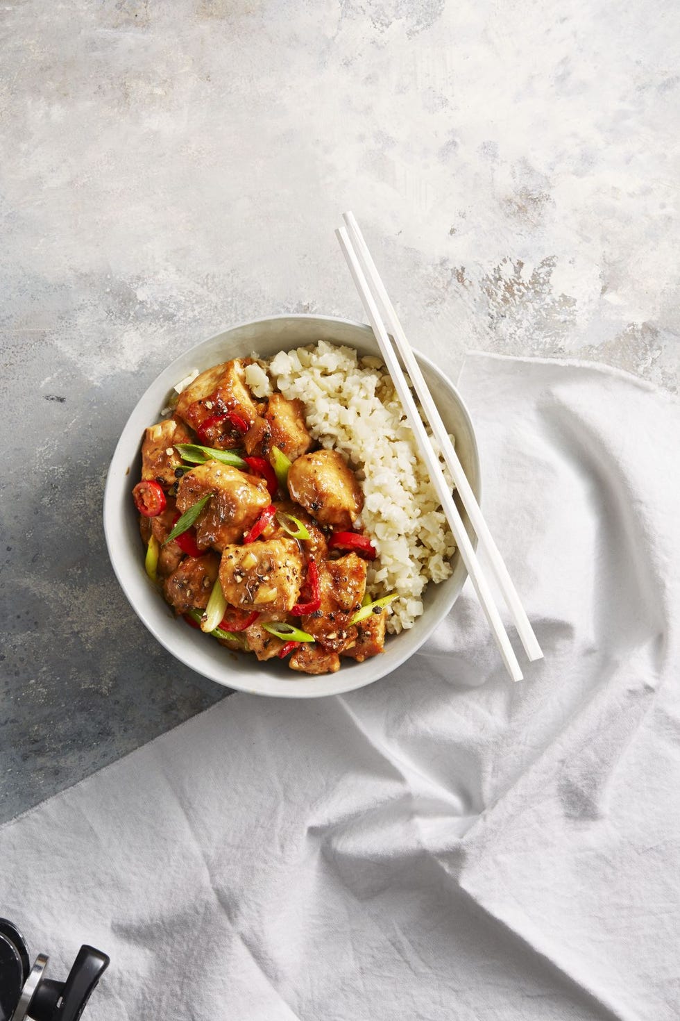 miso chicken with cauliflower rice in a white bowl