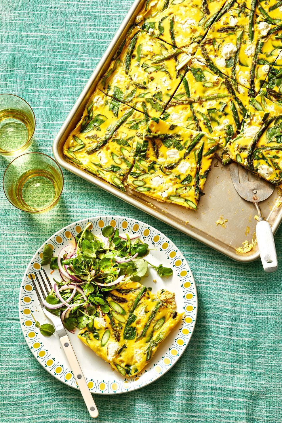 a sheet pan with a frittata and a small plate with a slice of frittata