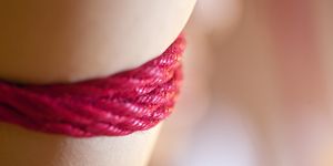 low dof macro red rope on human skin abstract