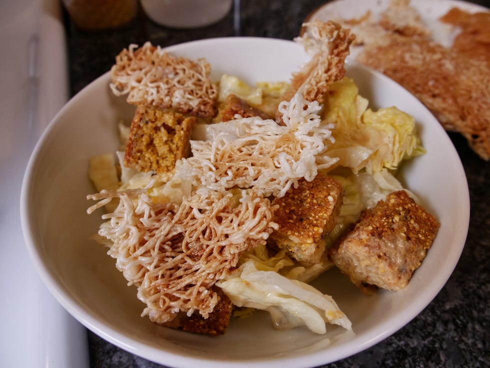 Cornbread panzanella with peanut sauce, iceberg lettuce and crispy rice noodles