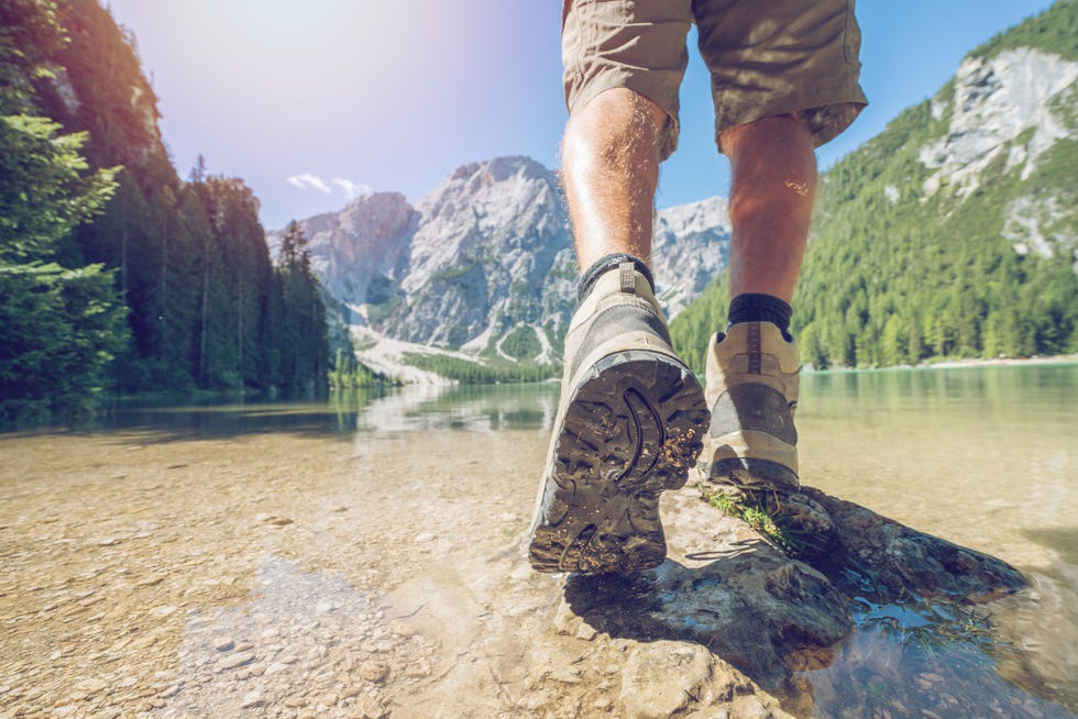 low section of hiker at mountain lake, dolomites, italy