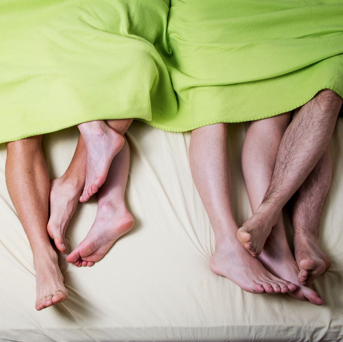 Low Section Of People In Bed