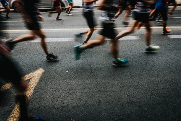 low section of people running on road in city