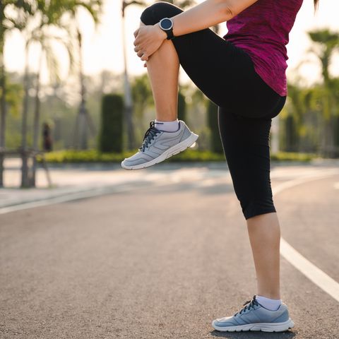 low section of woman exercising on road