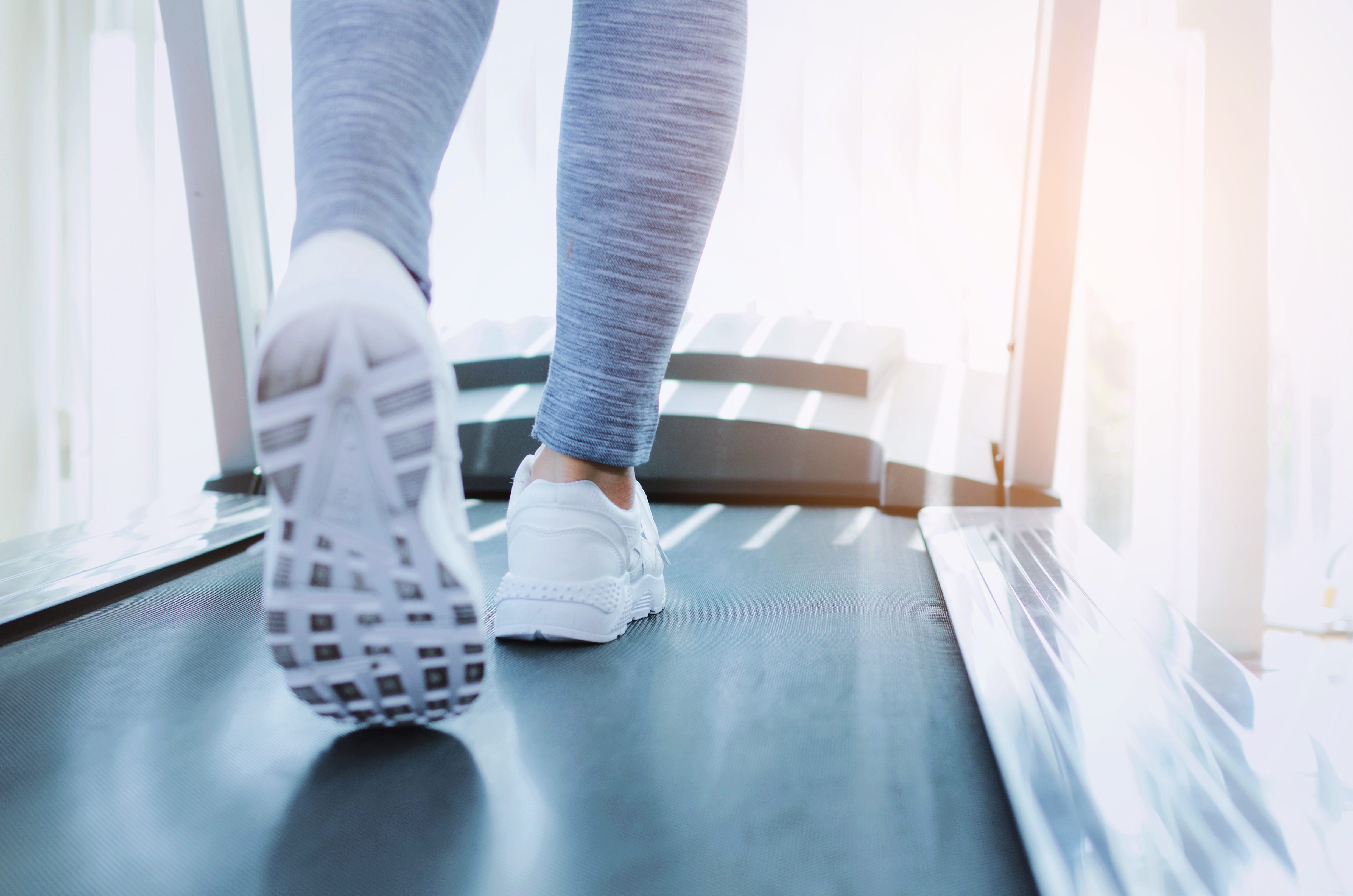 Low Section Of Woman Running On Treadmill