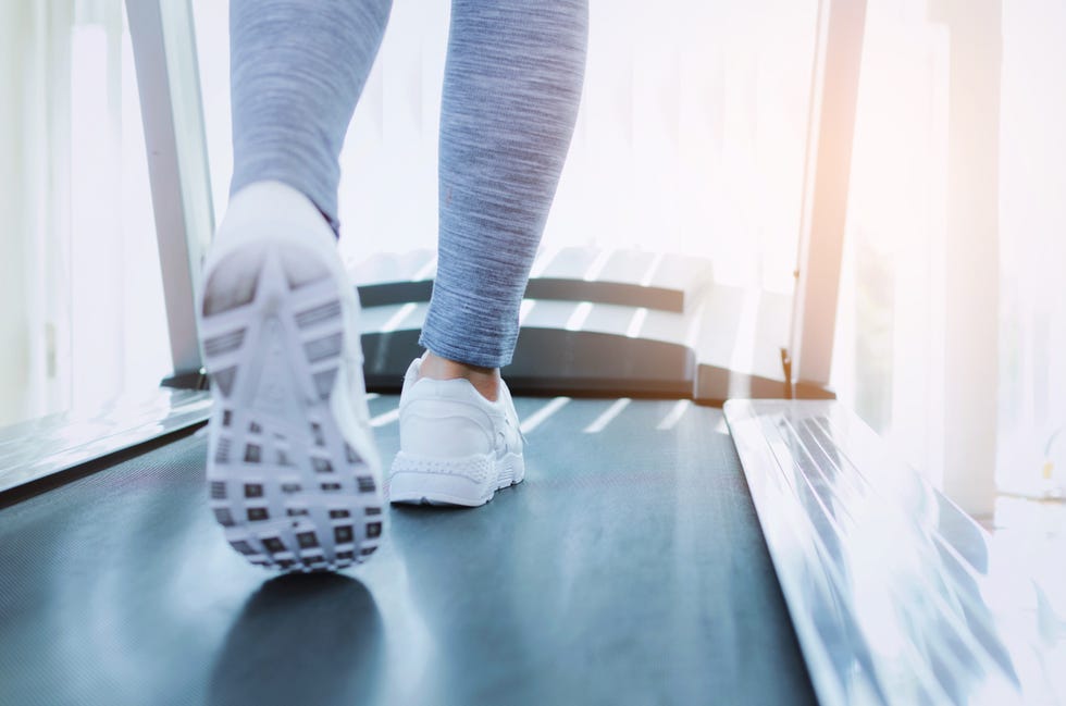 Low Section Of Woman Running On Treadmill