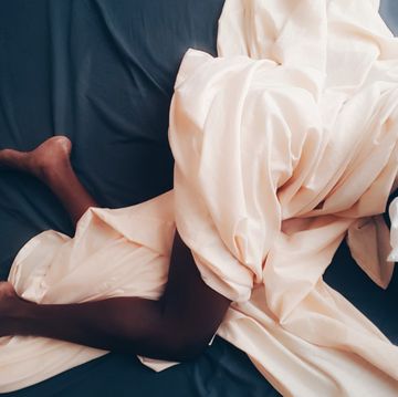 low section of woman sleeping in bed
