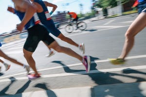 low section people running fast in the city, defocused sports background