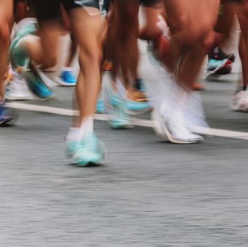 low section unknown people running marathon, defocused sports background