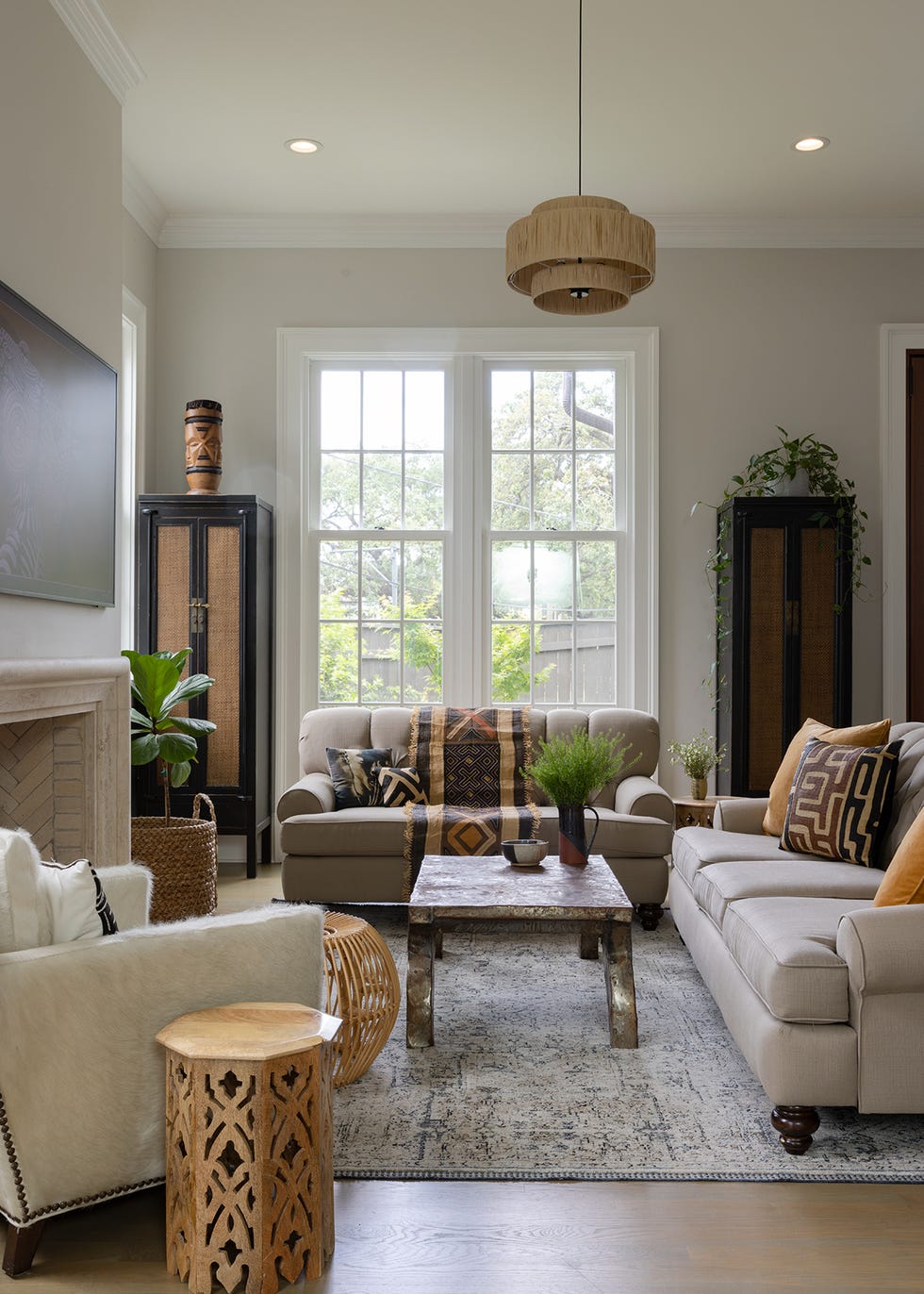 a living room with a large window and mixed styles