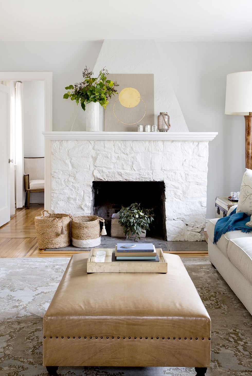 a living room with a fireplace and light gray walls