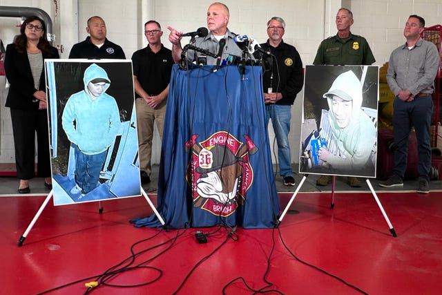 a police officer standing at a podium answering questions with photos of danelo cavlcante on either side