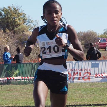 a person running on a grass field