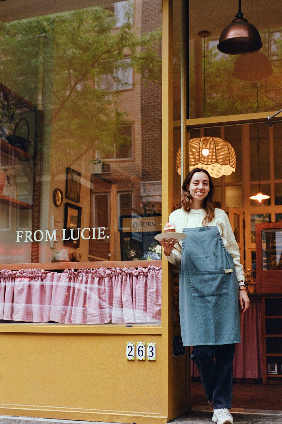 lucie franc de ferriere stands outside her cake bakery, from lucie in new york city, may 2023