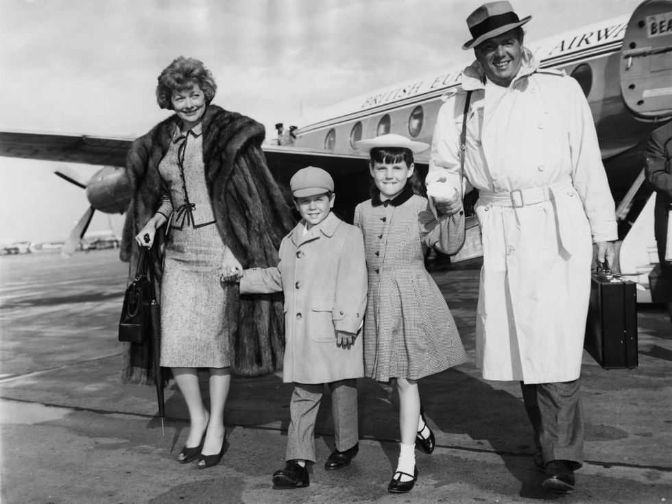 Lucille Ball and her husband Desi Arnaz arrive at London Airport with their children Lucie and Desi Jr