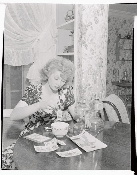 lucille ball helping to prepare cloth from pattern