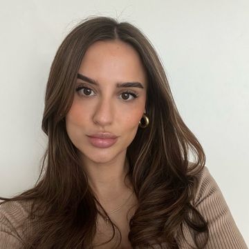 lucy watson pictured in glam selfie with tousled curls, wearing gold hoop earrings