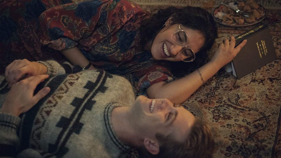 a man and woman lying on the floor and smiling