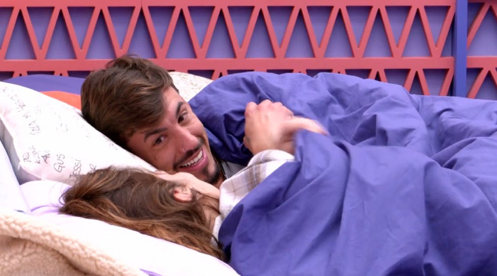 a man and woman lying on a bed