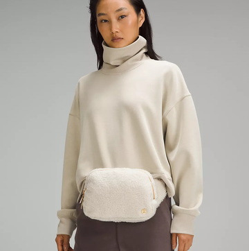 a person wearing the white furry lululemon belt bag