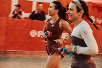 participants running in a race event with a cheering crowd in the background