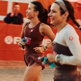 participants running in a race event with a cheering crowd in the background participants running in a race event with a cheering crowd in the background