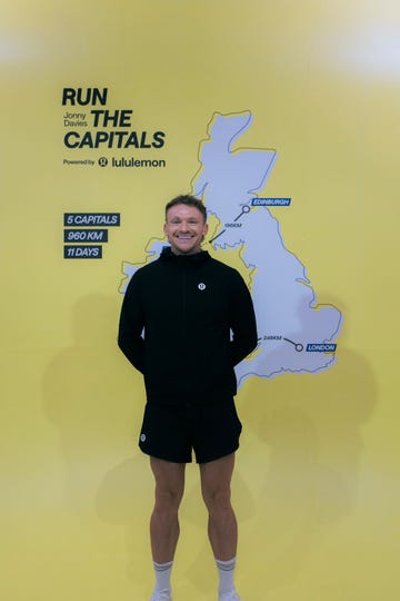 jonny davies standing in front of a map for his run the capitals challenge