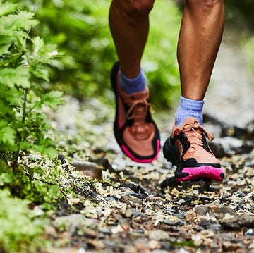 RWD Person running on a natural trail wearing athletic shoes