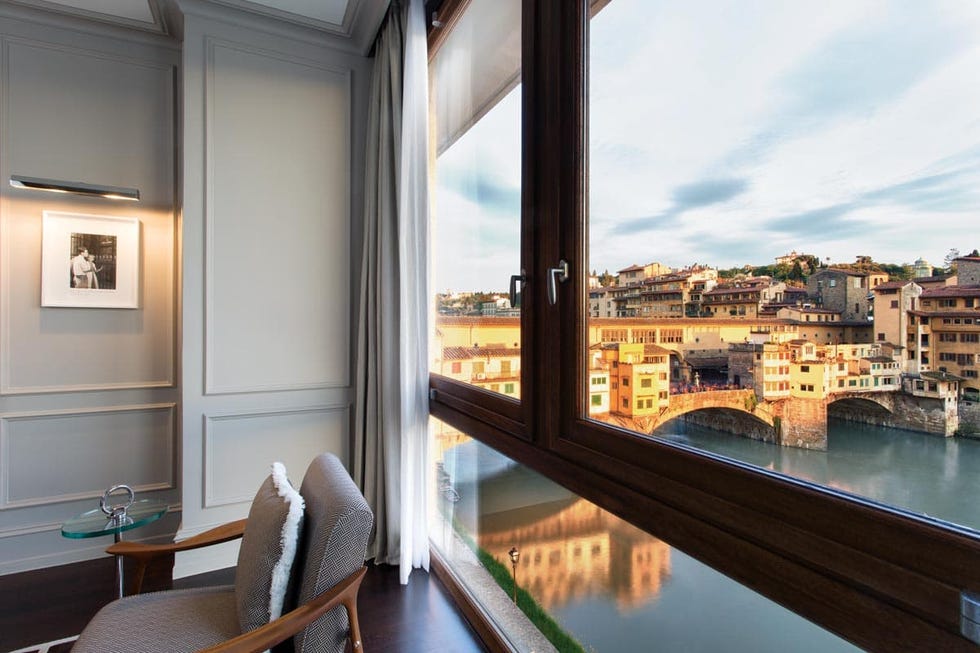 view outside the window of a room in portrait firenze hotel, with a direct look on the ponte vecchio bridge and oltrarno neighborhood on the other side of the arno river