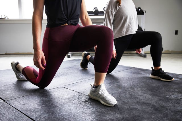 women doing a lunge in a gym