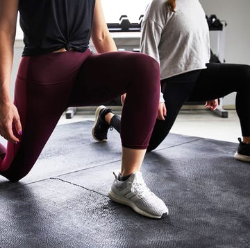 Women doing a lunge in a gym women doing a lunge in a gym