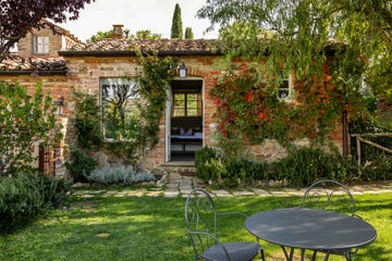 a backyard with a table and chairs