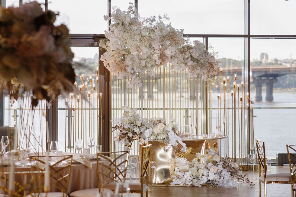 luxurious indoor wedding decorated in white and gold