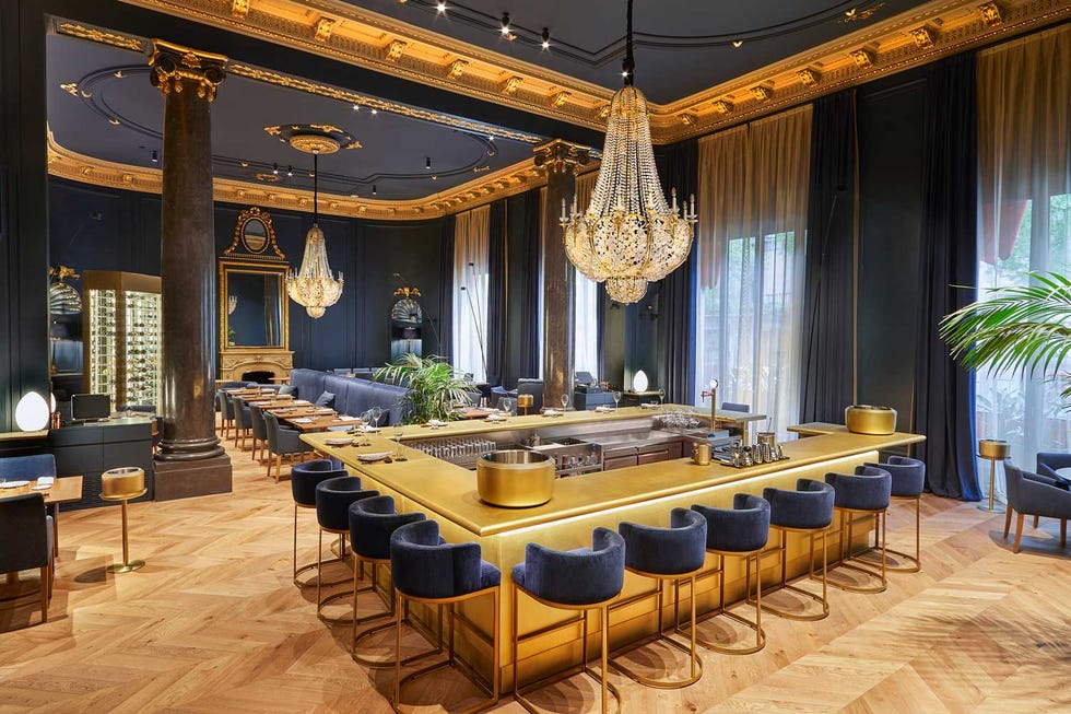 an elegant room with tables and chairs and a bar