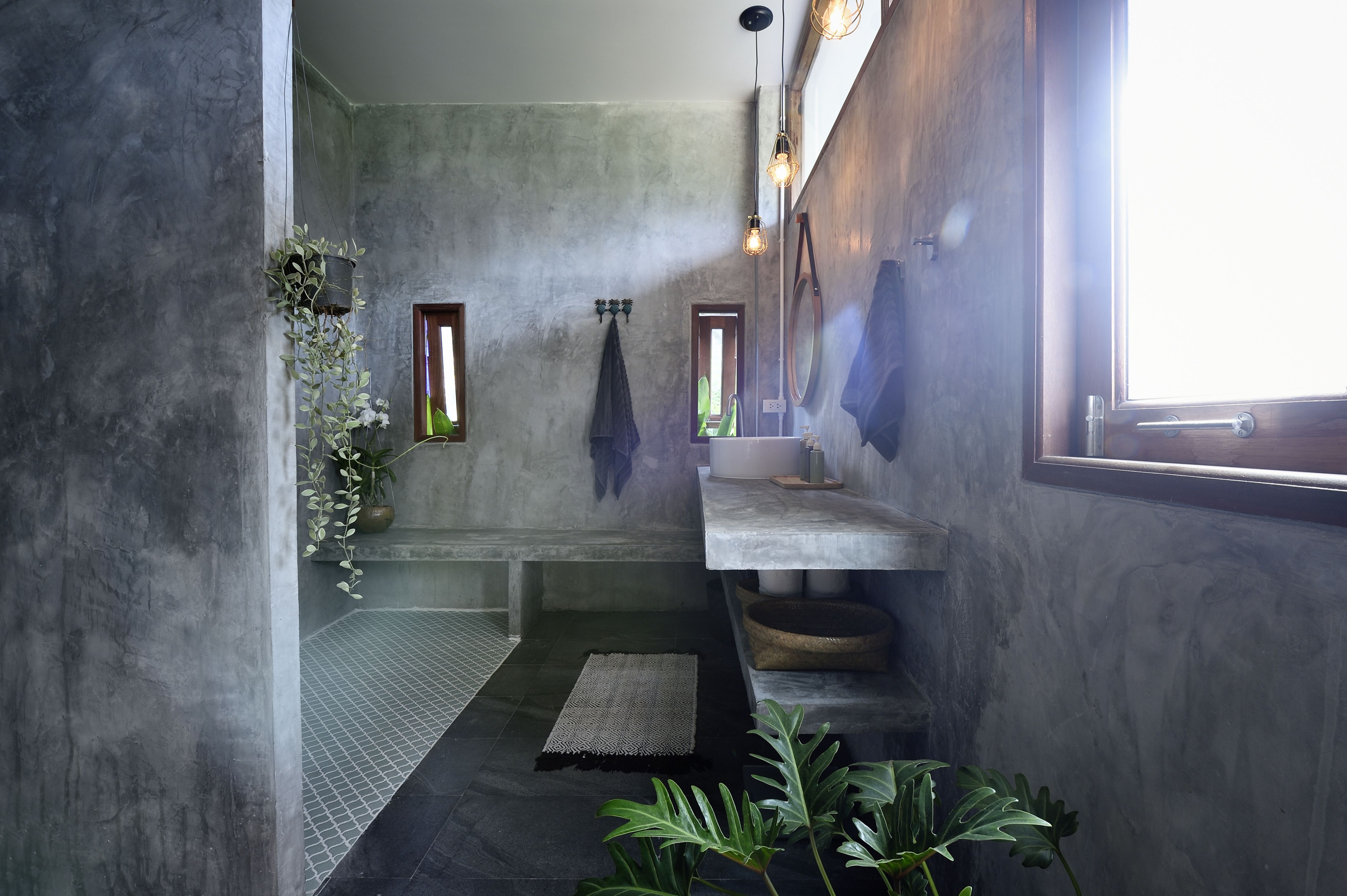 https://hips.hearstapps.com/hmg-prod/images/luxury-concrete-and-tile-bathroom-royalty-free-image-1652816976.jpg