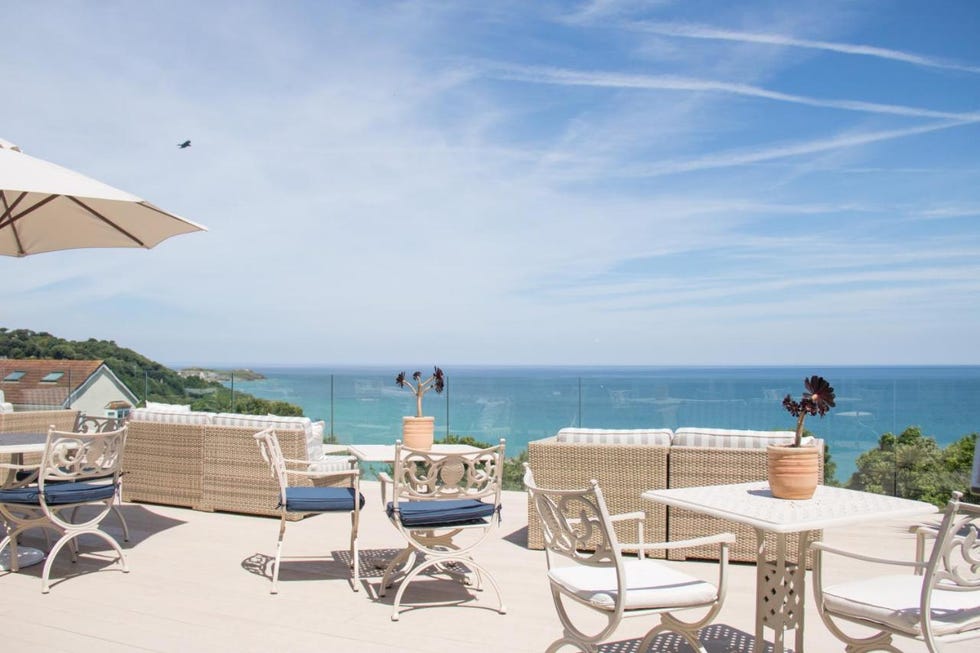 a beach with chairs and tables