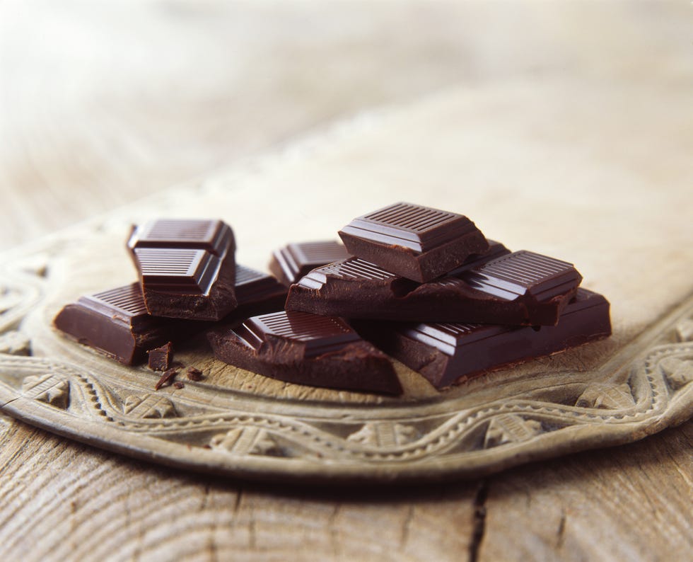 luxury dark chocolate broken on vintage wooden board