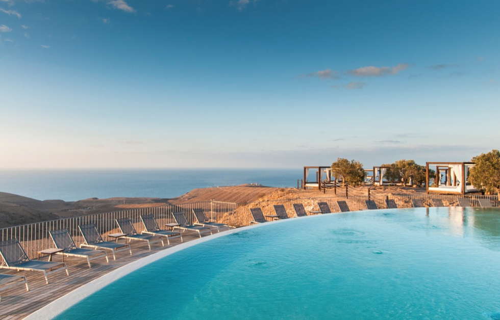 a pool with chairs around it at salobre hotel resort and serenity