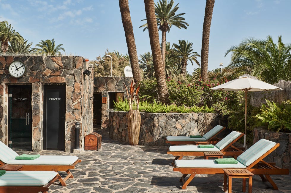 a patio with sunloungers by the spa at seaside palm beach