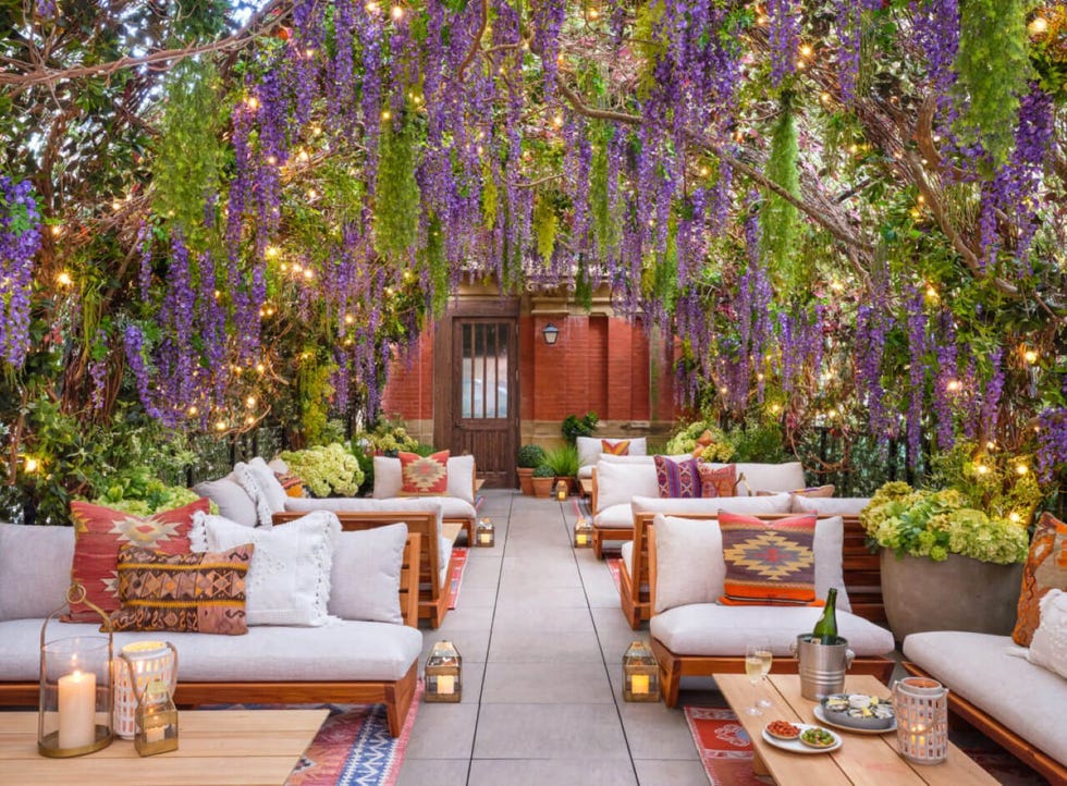 an indoor room with wisteria and comfy seating